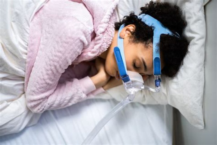 What disorder is treated with a mask CPAP that keeps breathing passages open while sleeping?